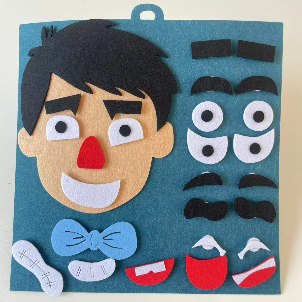 Jardín de infantes educación temprana para niños expresión facial rompecabezas fieltro tela no tejida material de mano bolsa de juguetes de educación temprana