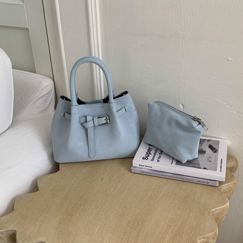 Diseño de nicho simple bolso de cubo portátil para mujeres 2026 nuevo estilo coreano de textura de alta calidad casual versátil bolso de tramo inclinado