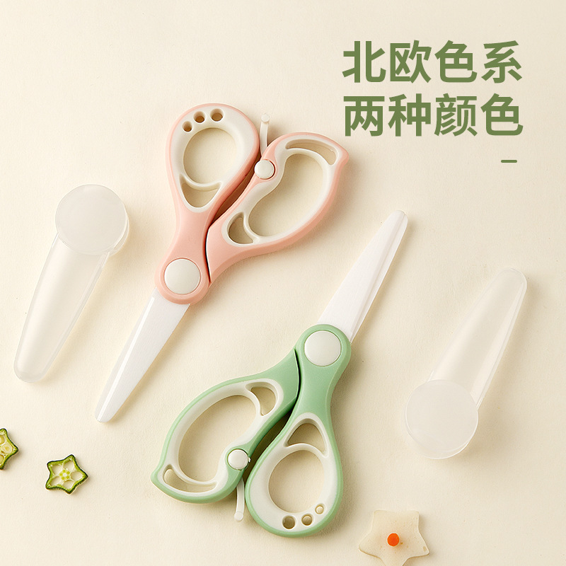 陶磁器のサプリメントは赤ちゃんの食べ物を切ります。はさみは携帯で肉を切ります。