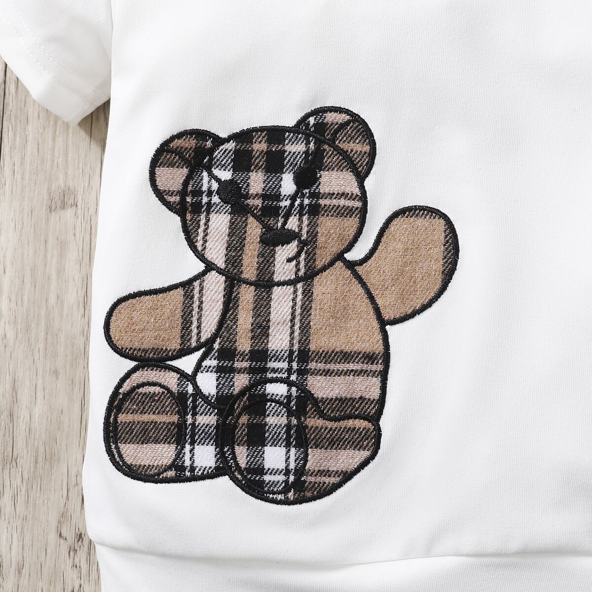 Las niñas de primavera y otoño 2023 nuevo estilo coreano oso popular impreso top de manga corta + falda a cuadros