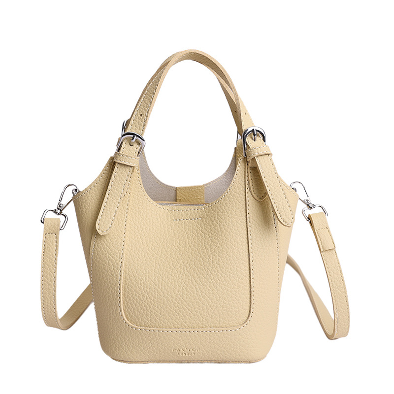 2026 nueva moda versátil cesta de verduras portátil bolso de cubo de agua de alta calidad litchi patrón ligero bolso de lujo bolso de mochila
