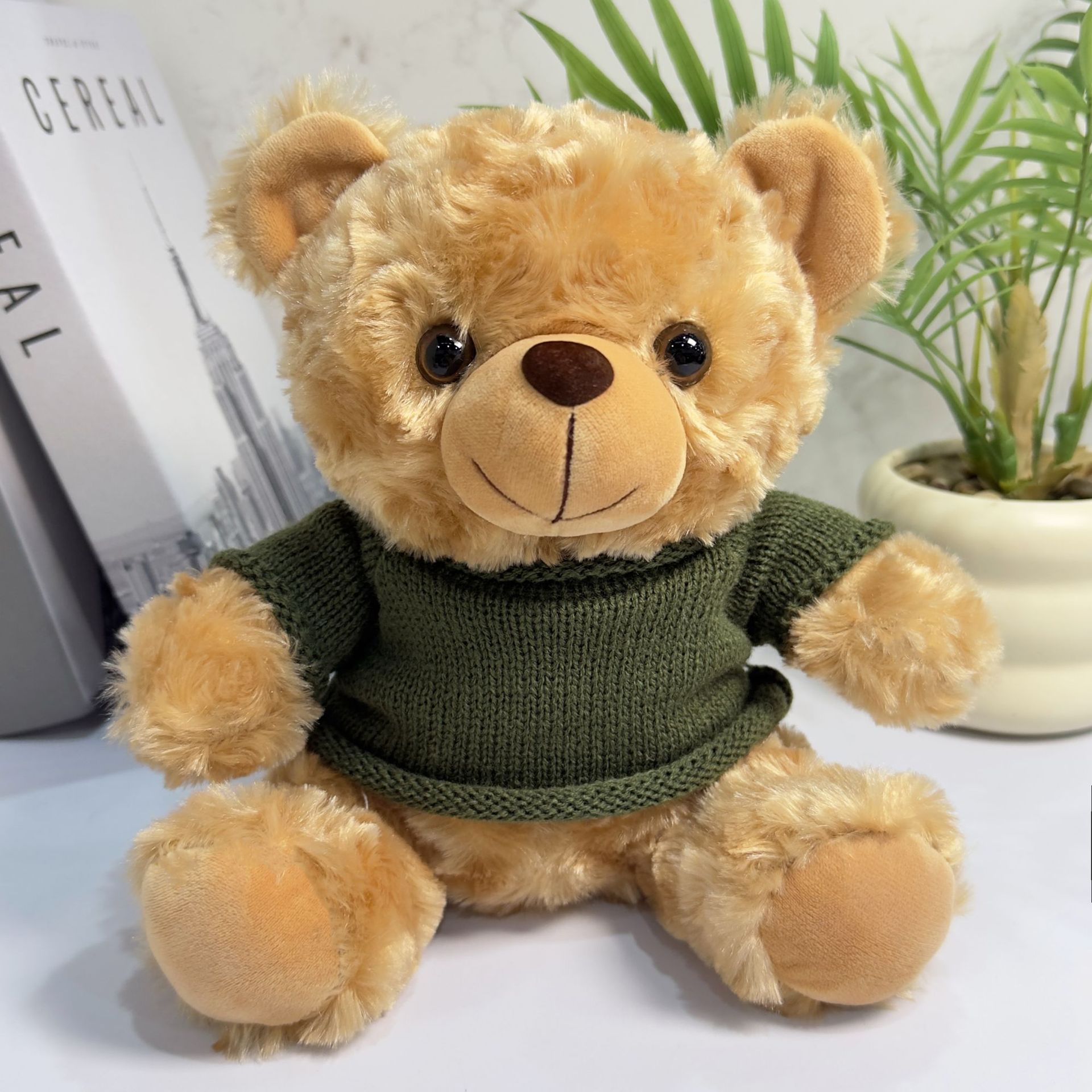 Suéter verde del oso marrón