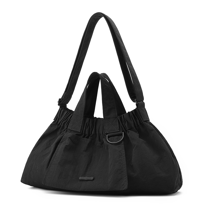 El nuevo diseño de nicho coreano del comercio exterior tiene un sentido del conocimiento de embarque a mano y una bolsa de mujer en el hombro es ligera, casual y plegable.