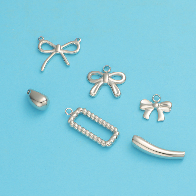 Foreign trade hot wholesale titanium steel twist box eggplant elbow through hole small water drop bow DIY jewelry pendant Foreign trade hot wholesale titanium steel twist box eggplant elbow through hole small water drop bow DIY jewelry pendant