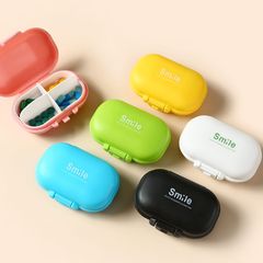Factory direct supply portable one-week macaron four-grid plastic small medicine box travel mini plastic storage medicine box with printing