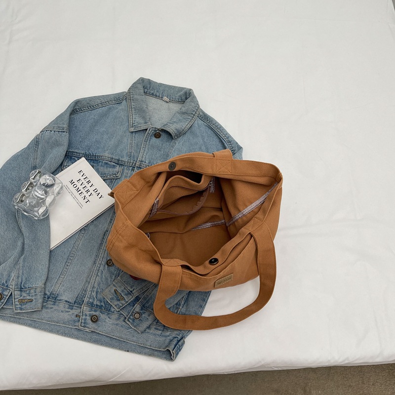 Bolso de lona para mujer 2024 nuevo bolso de hombro de gran capacidad de color sólido casual simple y versátil bolso de clase al por mayor