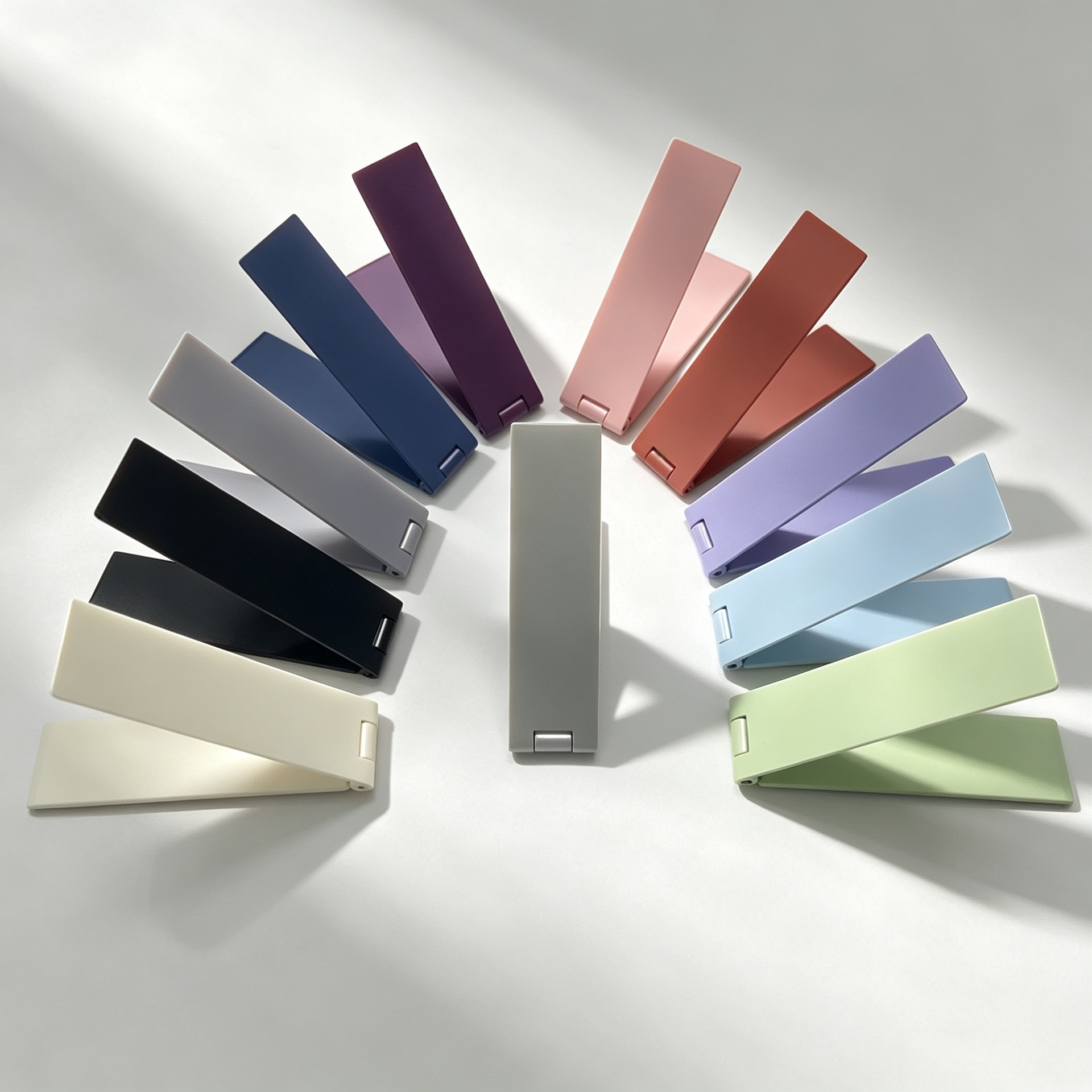 Manufacturer's slim, foldable, lightweight, mini desktop phone stand with adhesive backing, multifunctional metal