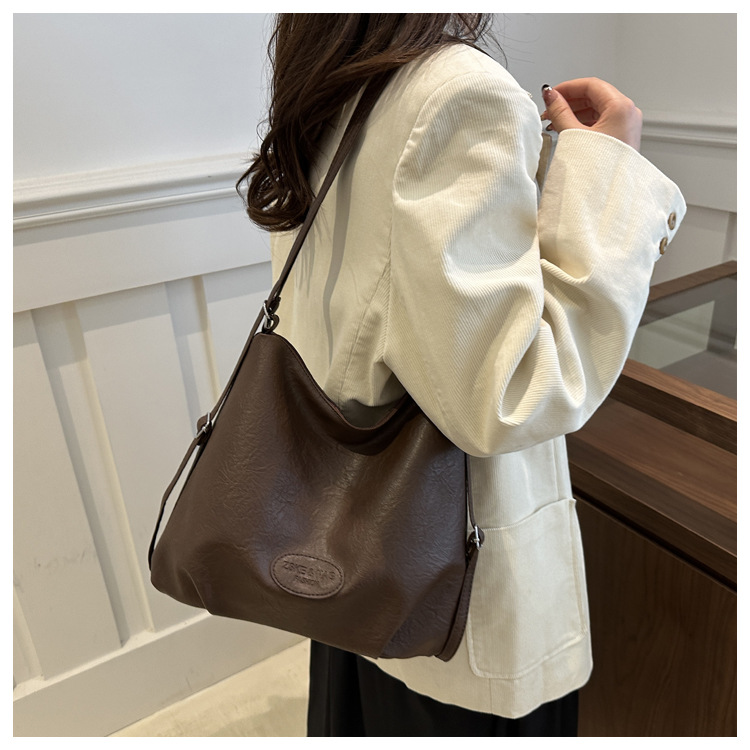 The 2024 new pleated tote bag is a large-capacity casual and fashionable backpack for women, featuring multi-functional texture and a single-shoulder crossbody bag undefined