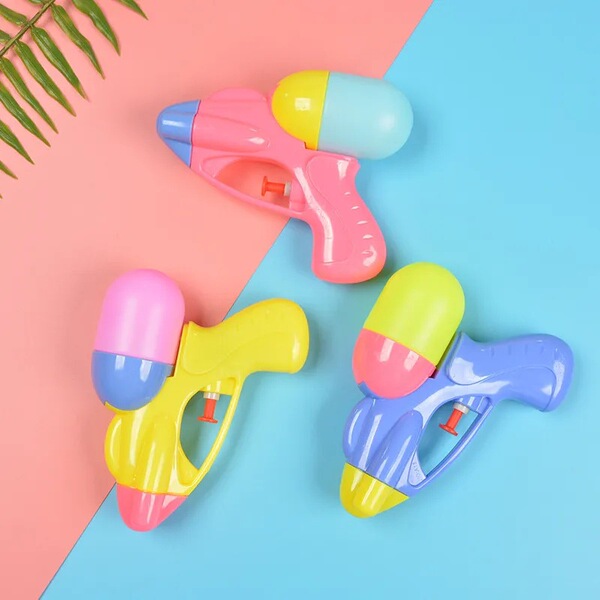 Summer beach travel water gun play in water