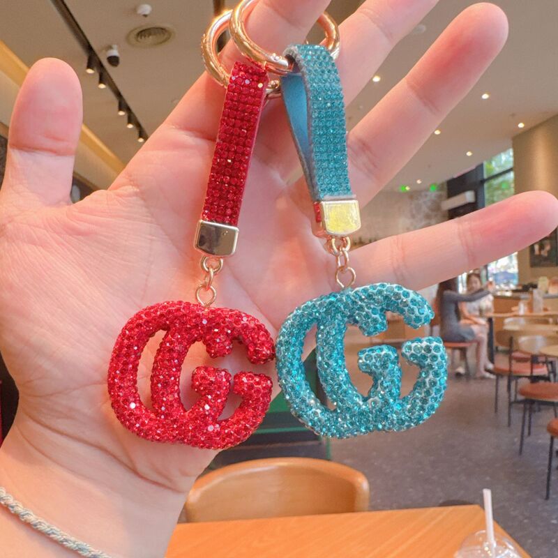 High-end ceramic keychain with a full diamond-studded Gucci logo, a small accessory for bags, and a delicate, cross-border design High-end ceramic keychain with a full diamond-studded Gucci logo, a small accessory for bags, and a delicate, cross-border design