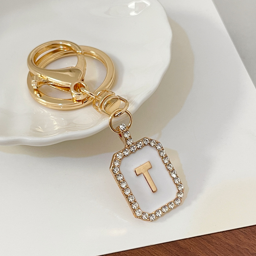 Nueva moda 26 cartas gota de diamante aceite llavero bolso del auricular pareja colgante vacaciones pequeño regalo al por mayor