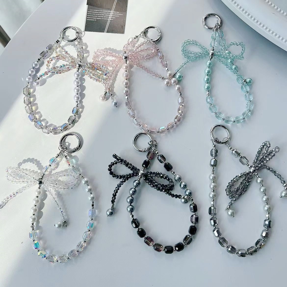 Lazo de perlas de lujo cadena de teléfono móvil cordón de teléfono móvil de alta gama cristal tridimensional corto exquisito cordón de muñeca ins