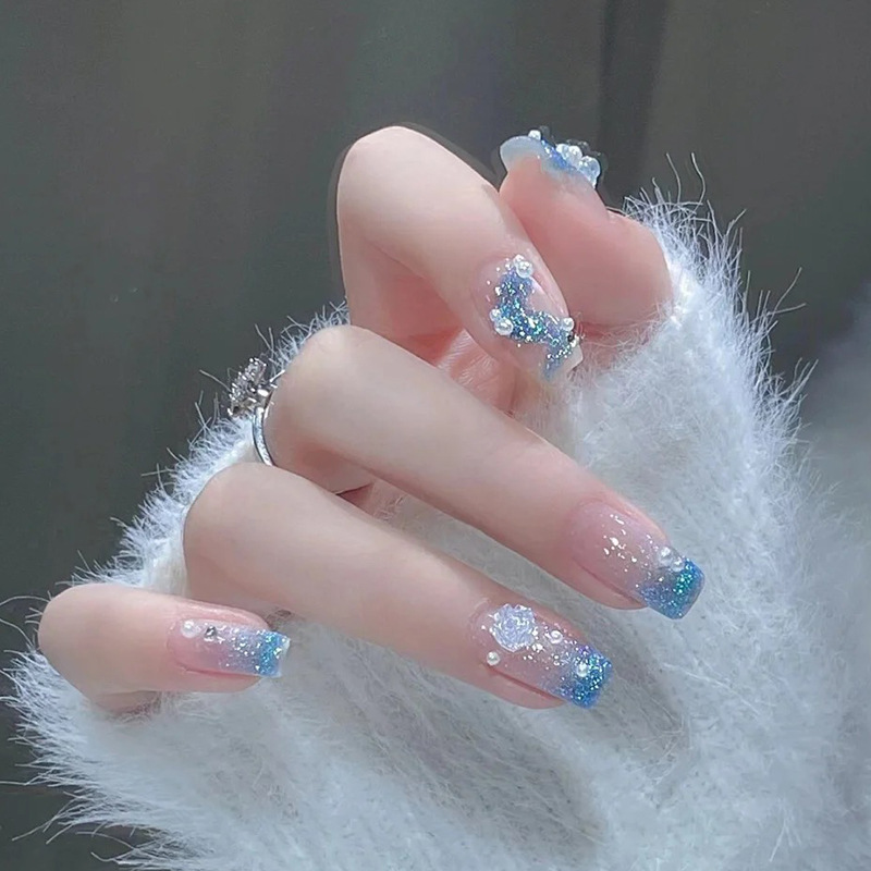Three-dimensional aurora camellia pearl nail art ice blue glitter powder ice through wearing a white fake nail sticker finished nail