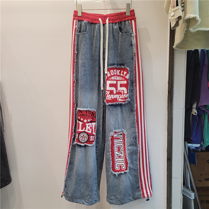 2026 primavera y verano nuevo estilo americano estilo callejero retro empalme jeans letras sueltas pegatinas pantalones largos de pierna ancha