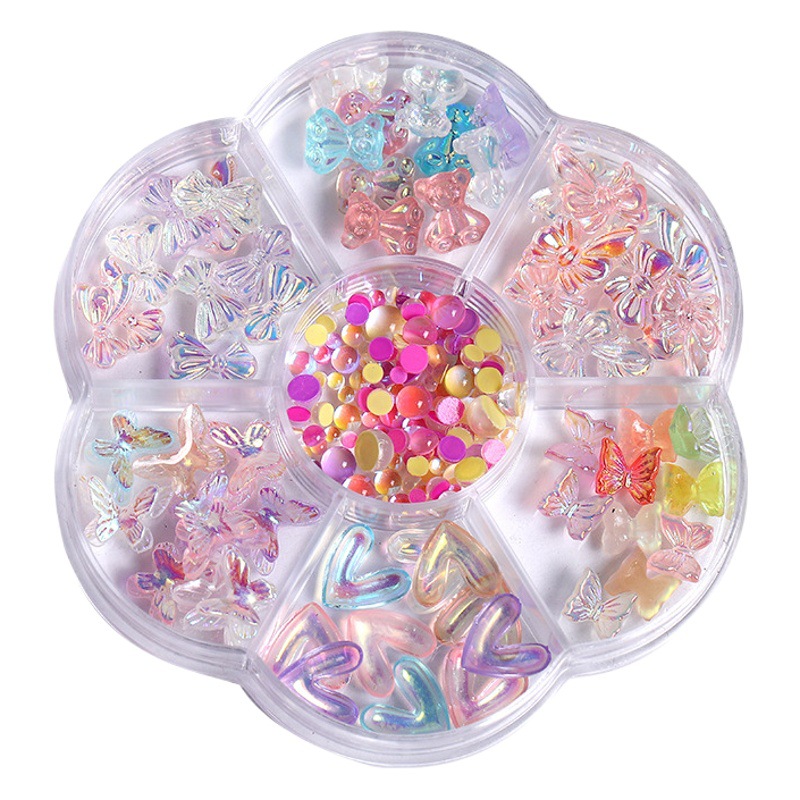 Lazo decorativo para uñas con perlas, ositos y pedrería brillante; bandeja organizadora de 7 compartimentos con materiales para decoración de uñas con flores secas.