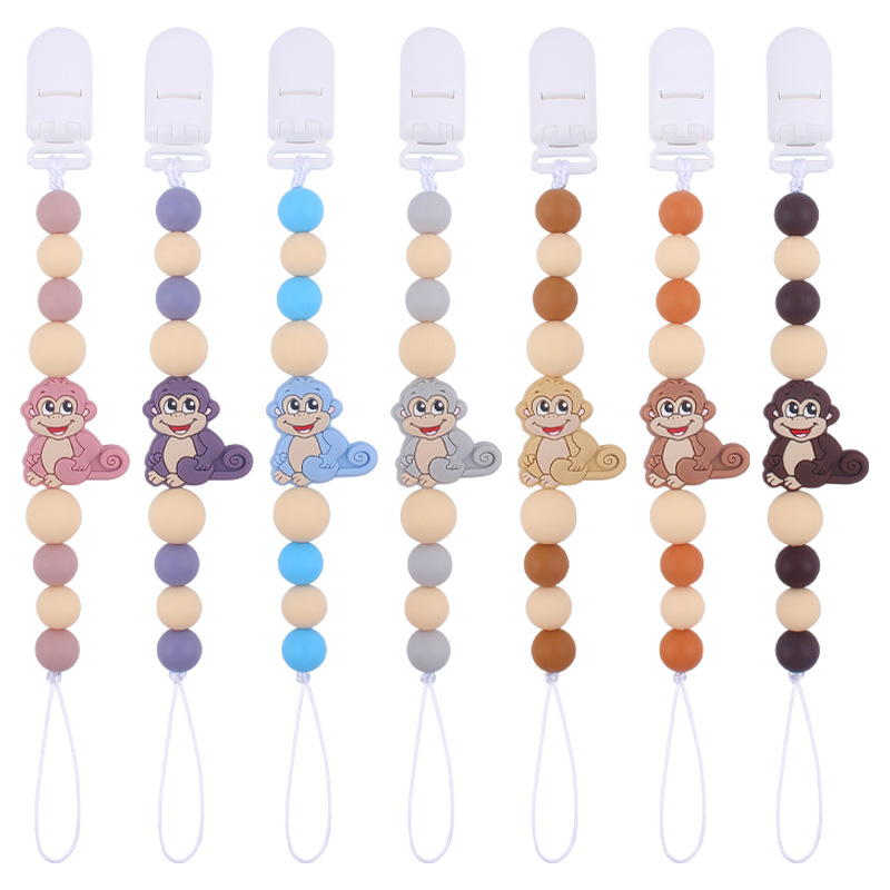 Nuevos suministros para bebés mono de dibujos animados mordedura de chupete de silicona lindo bebé creativo cadena anti-gota cadena