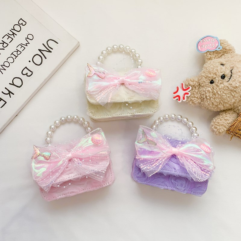 Dulce princesa bolso de hombro de perlas de aire extranjero bolso de mano bebé 2025 nuevo bolso de moda para niños