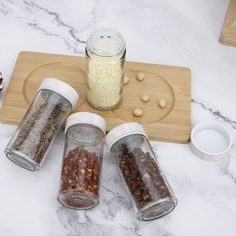 Suministro directo de fábrica de acero inoxidable traje condimento frasco de vidrio condimento botella cocina madera grano inferior comino pimienta condimento botella