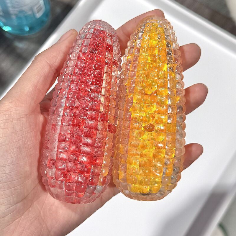 瑠璃水晶のトウモロコシのつまみの音楽はボールのトウモロコシの可塑性のスプリングバックのつまみの音楽の減圧のおもちゃをつぶして砂を流します。|undefined