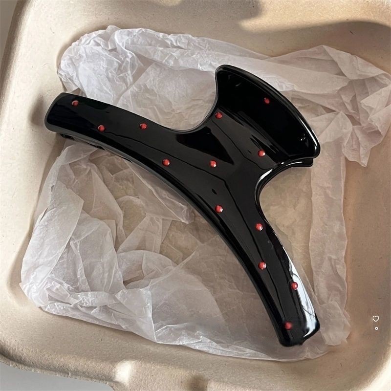 Black clothes hanger with red dots
