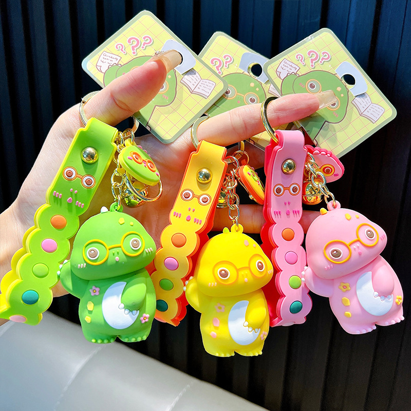 Keychain dinosaurio auténtico lindo bolso colgante de goma blanda llavero de automóvil muñeca pequeña máquina de regalos al por mayor image 2