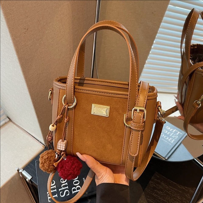 Bolso coreano retro de alta calidad bolso de cubo de agua mujer otoño / invierno 2025 nuevo simple bolso de hombro mochila casual