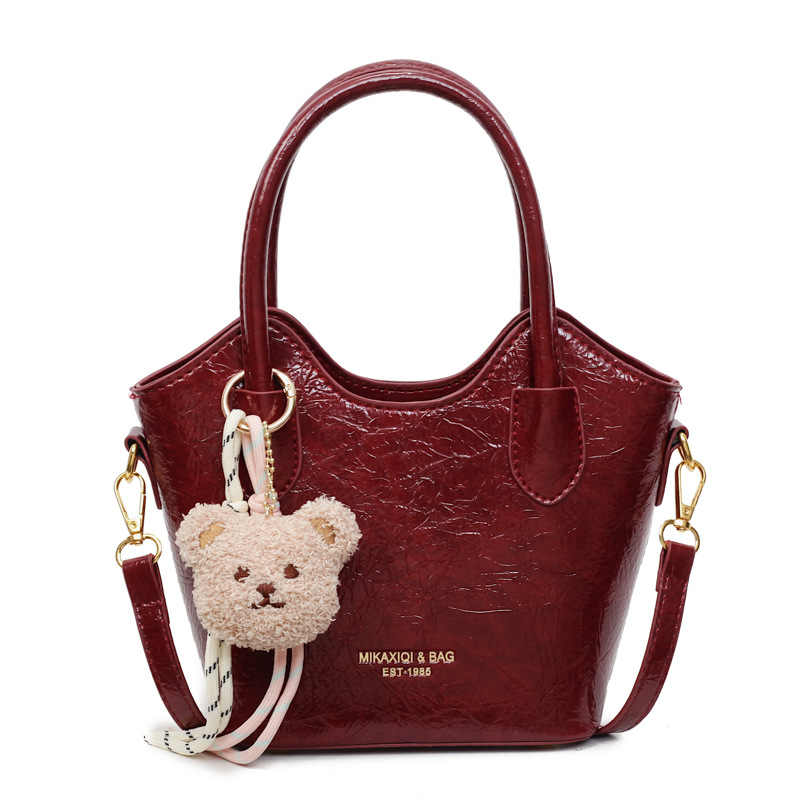 Versión coreana del bolso de cubo de mano casual simple para mujer 2025 nuevo bolso de hombro de viajero de todo fósforo bolso de mensajero de tendencia de moda