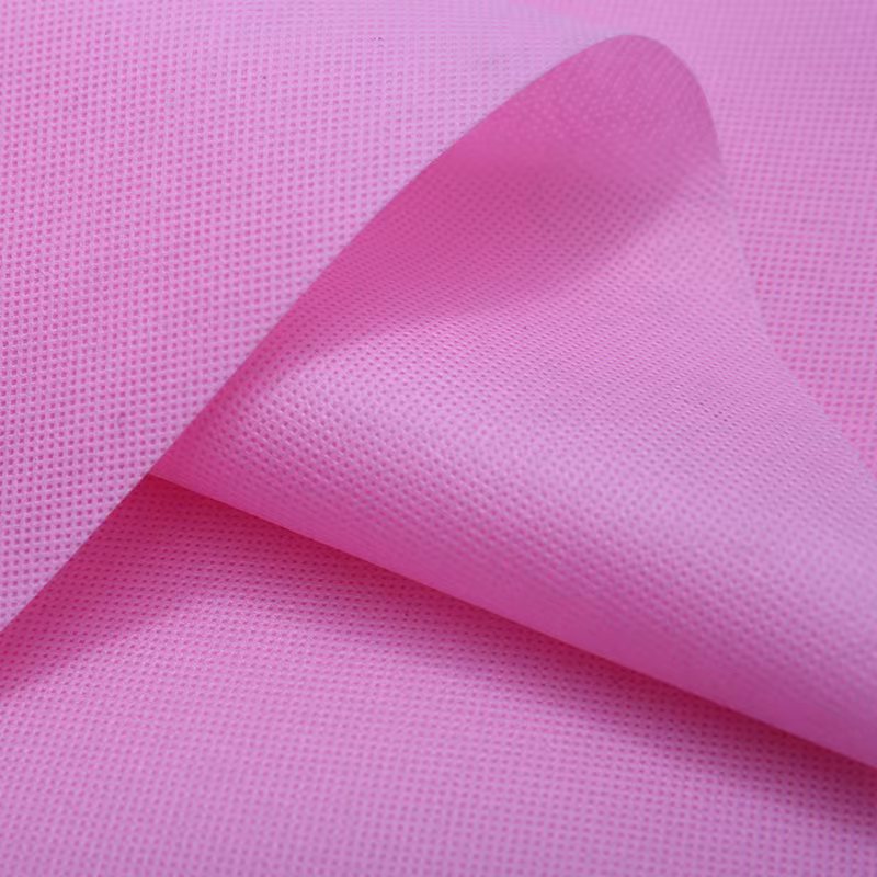 粉色新料彩色无纺布围裙鞋套袖套印花加工可分切折叠袋定做