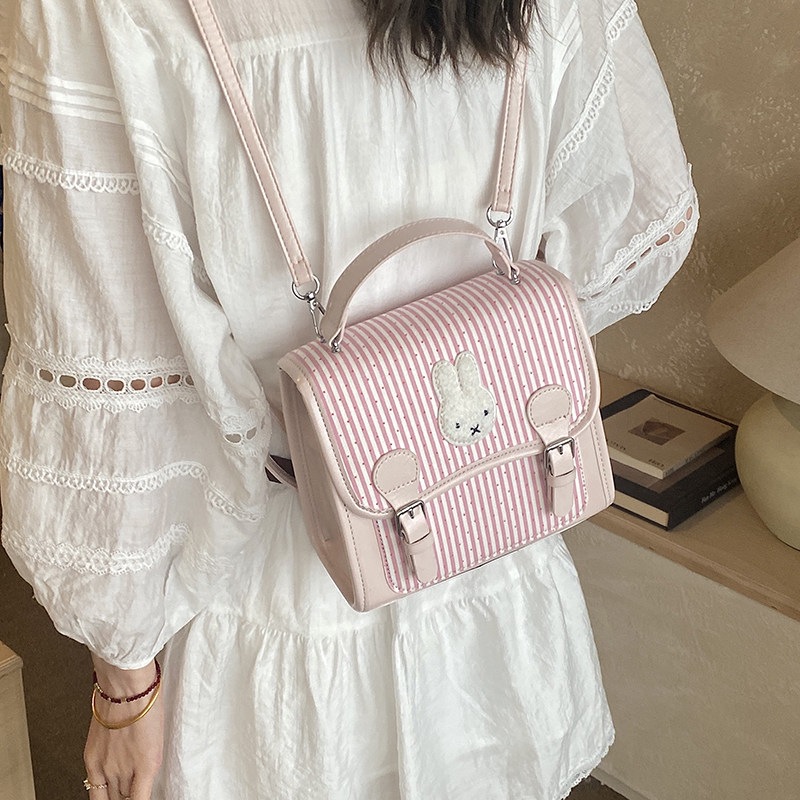 Caricatura de dibujos animados estilo nuevo diseño estilo mochila universidad flip mochila de nicho de moda 2026 rayas para mujeres