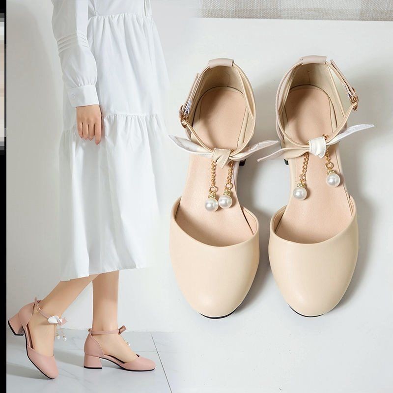 Sandálias de cabeza redonda de talón grueso para mujeres 2026 primavera y verano nuevo estilo de botón de botón de arco de talón alto de hadas zapatos de ventilador