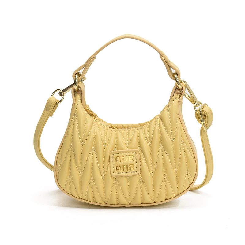 Versión coreana del bolso de hombro de niña de color sólido simple estilo occidental mini bolso de la axila portátil del bebé nuevo bolso de los niños plisado