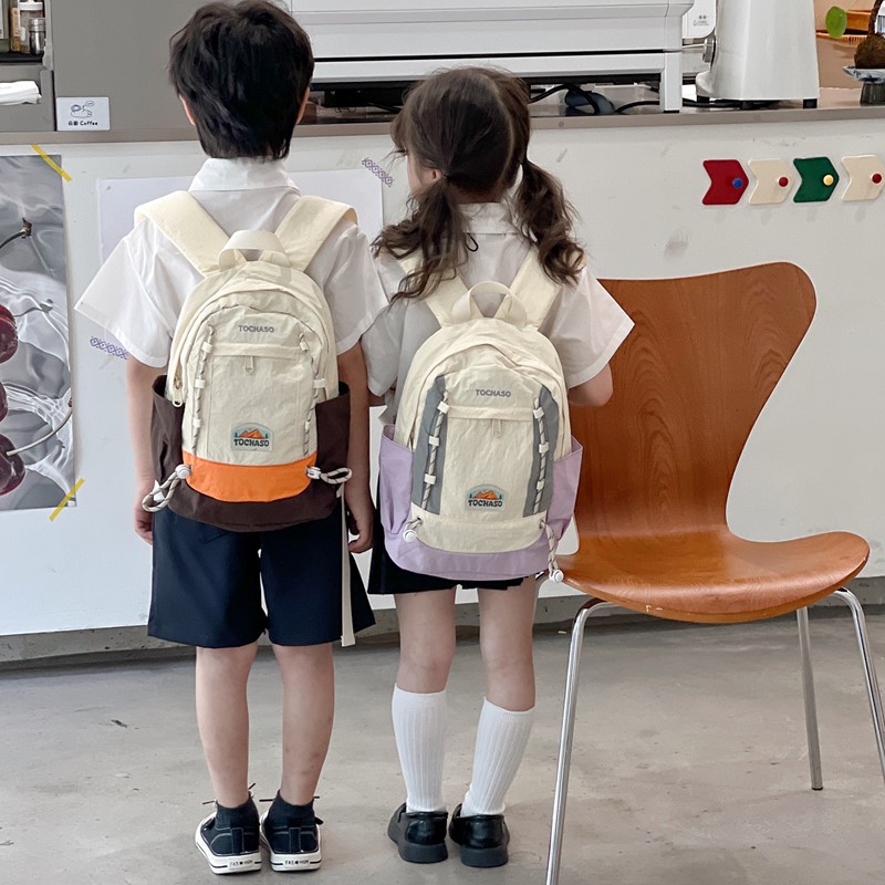 Mochila de moda coreana para niños y niñas, mochila de alta capacidad para estudiantes de escuela primaria, nueva mochila para niños con cuerda extranjera.