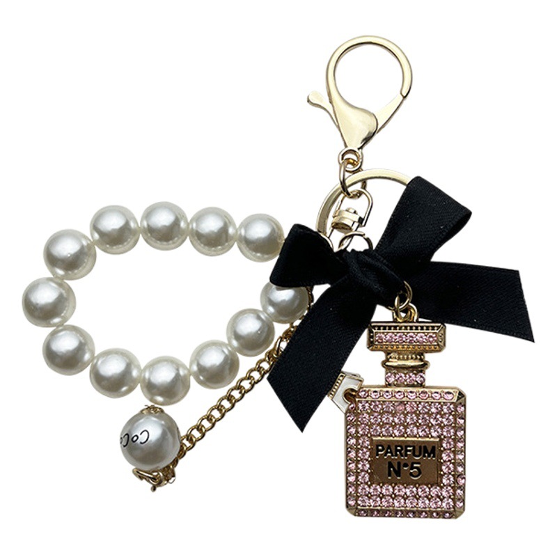 Estilo coreano aleación diamante arco perfume botella llavero creativo perla cadena bolsa colgante exquisito llavero para las mujeres