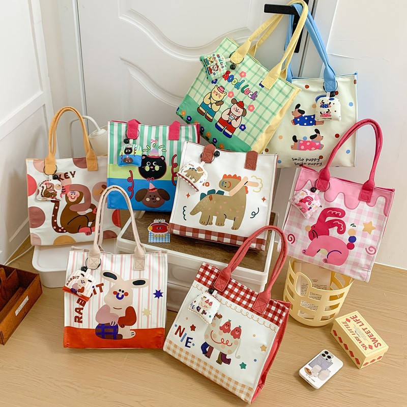 Caricatura de niños y niñas, bolsos de hombro de gran capacidad, bolsos de nicho de diseño, bolsos de mano nuevos lindos para niñas