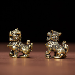 A pair of solid brass lions in pure yellow copper, playing a ball of embroidered silk, a pair of door guardian lions, a decorative pair of brass lions, a small tea pet.