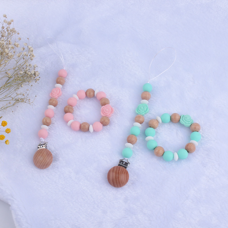 Nuevo bebé de dibujos animados de silicona de doble cara Rosa mordedor calmante bebé anti-gota cadena pulsera traje de juguete