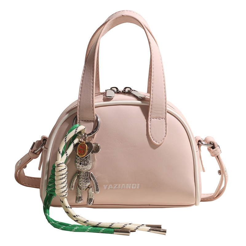 Bolsa de bolos para mujeres 2025 nuevo bolso de hombro de mano de color universal nicho simple de moda alta sensación de mochila