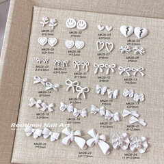 ネイルアクセサリーの新しい白いフロストシリーズの高級合金塗装スタイルに合わせて、蝶結びのアクセサリーの香り風をつけます。