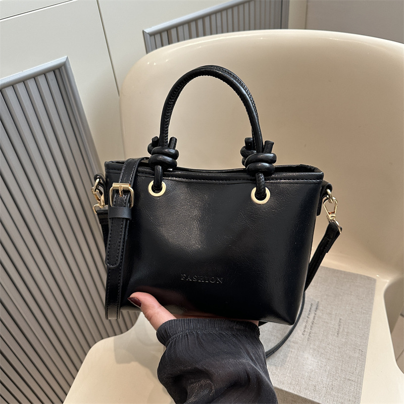 Bolso de moda simple 2025 primavera nuevo retro textura bolso de cubo de moda color sólido viaje mochila de hombro