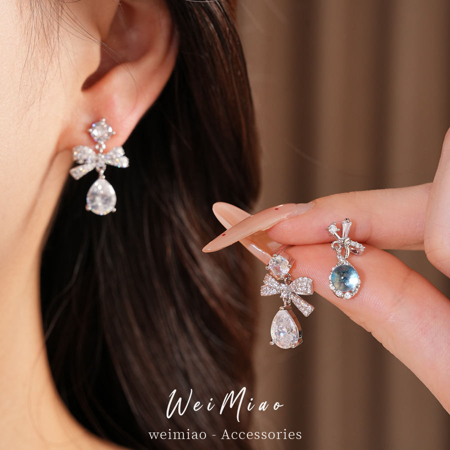 Aguja de plata zircon arco gotas de agua simple temperamento moda aretes de aretes ligeros de lujo alta sensación de aretes al por mayor