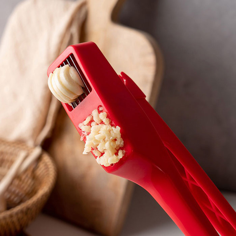Prensa de ajo manual de plástico de doble propósito dos en uno se puede cortar en rodajas ajo de ajo doméstico artefacto de prensa de ajo
