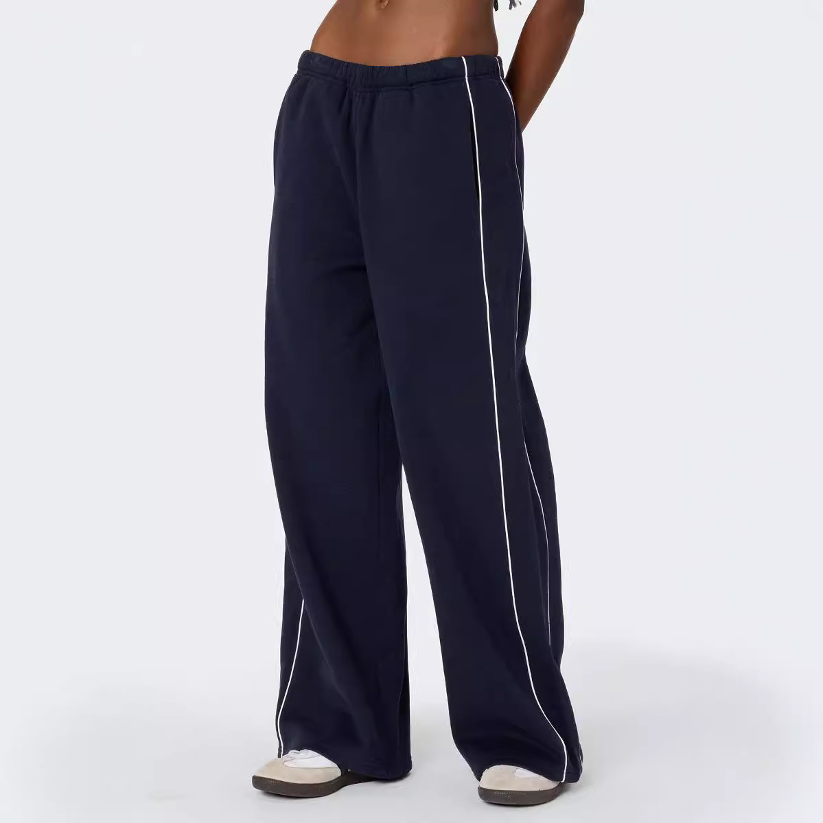 Europa y los Estados Unidos transfronterizos otoño y invierno personalidad callejera mujer blanco contraste rayas laterales casuales cintura elástica pantalones deportivos rectos