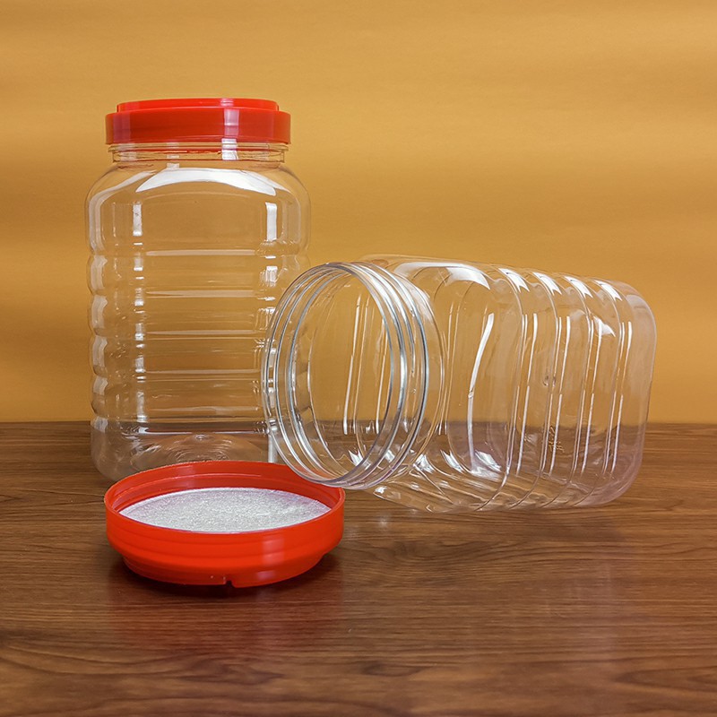 Botella de miel de plástico cuadrangular sellado con tapa de poliespecificación de gran calibre de embalaje transparente de grado alimenticio