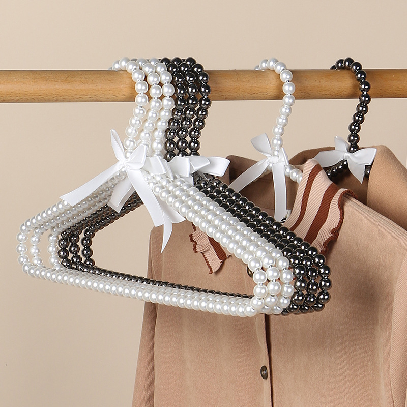 Tienda de ropa de mujer perla lujo ligero vestido retro arco adulto percha de ropa infantil estilo europeo hadas soporte de abrigo