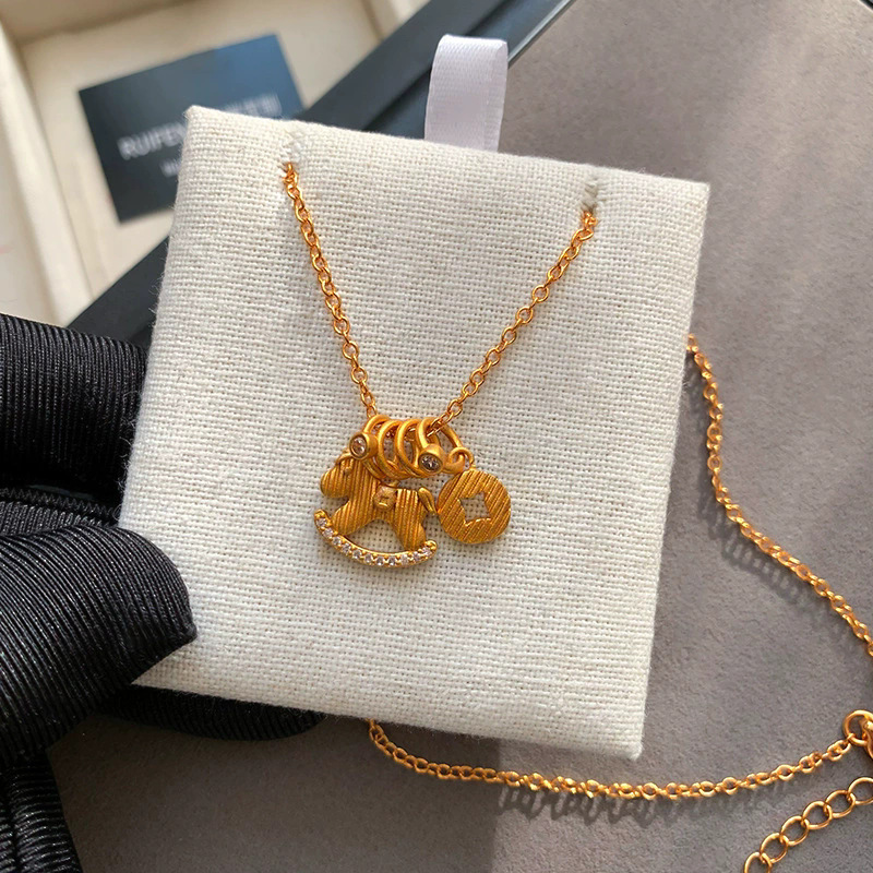 Collier cheval à bascule style chinois effet glacé doré femme_voghion.com