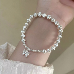 車の花の丸い玉の蝶結びのブレスレットの女性の手作りの弾力の縄は軽くて豪華で小さい大衆のデザイン感のファッション的な猫の目の玉の装飾品です。