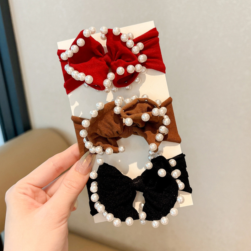 Arco de perla máscara anillo de cabello femenina baja cuerda de cabello bola adornamiento de cabello correa de cuero cuerda de cabello al por mayor