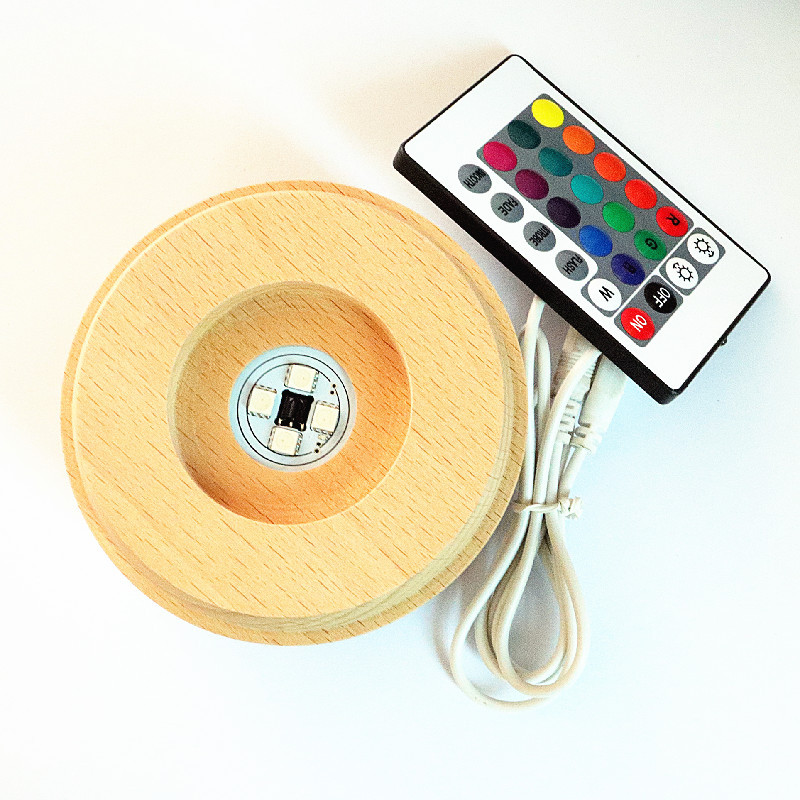 Bola de cristal giratoria caja de música LED base luminosa luz de la noche de dibujos animados pequeña base de la decoración