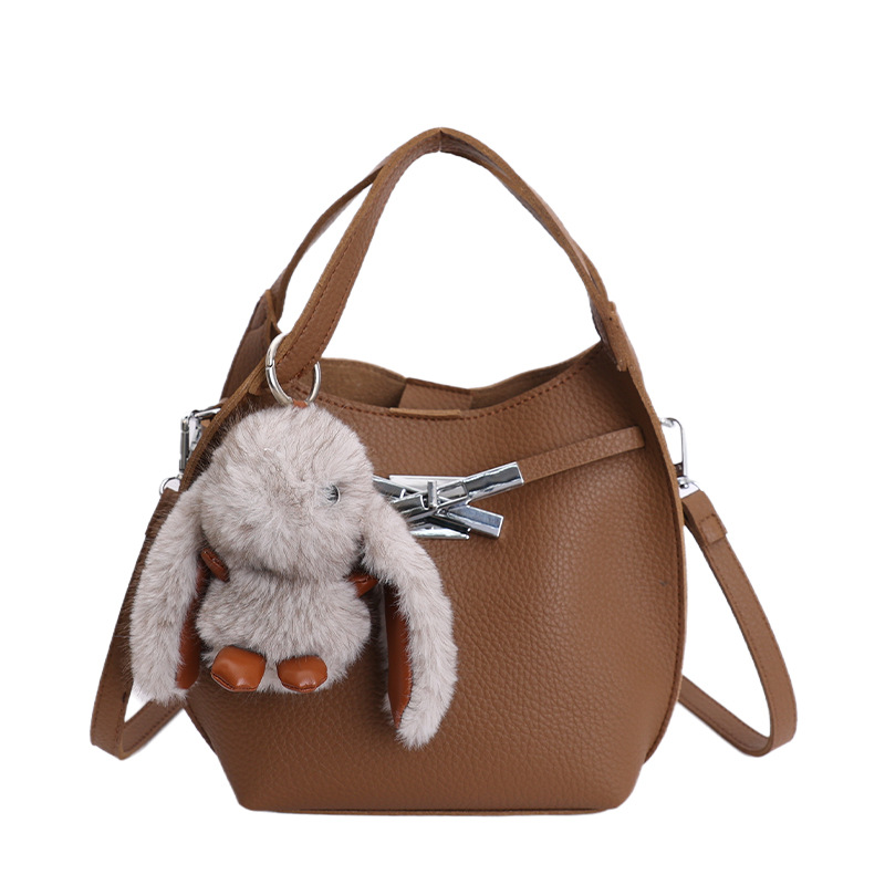 Bolso de mujer nuevo estilo coreano nicho de moda lichi bolso de cubo portátil de alta sensación de ocio mochila de viaje