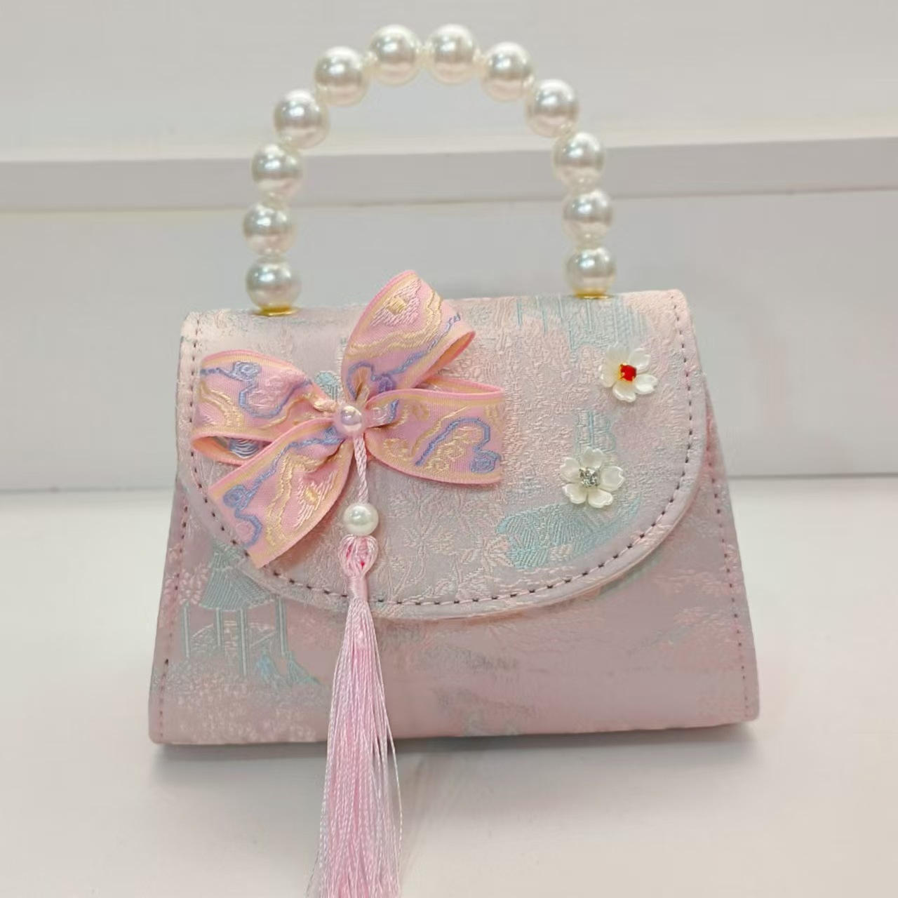 Bolsas de niños arco de estilo chino borda de niña pequeña princesa perla bolsa de cambio de mano al por mayor